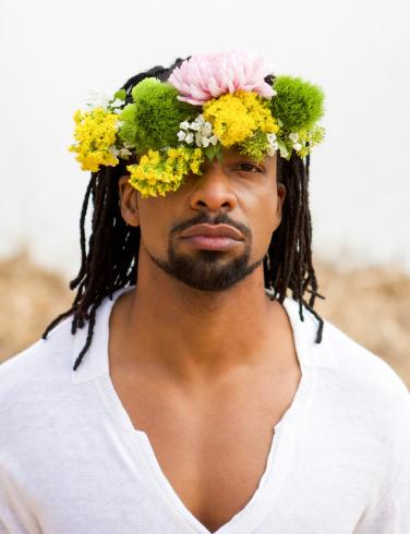 Jericho Brown headshot with a flower crown